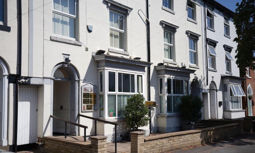 White multi-story British commercial building with bay windows