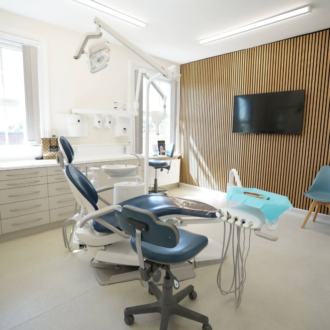 Modern dental office with blue chair and wood accent wall