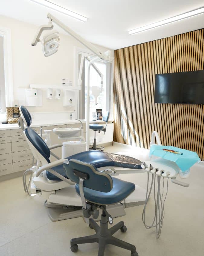 Modern dental office with blue chair and wood accent wall